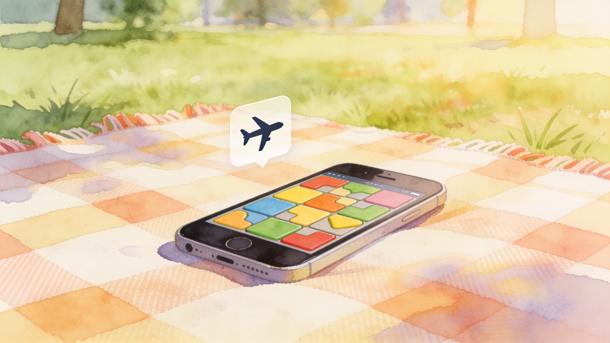 Phone with a colorful tile puzzle on a picnic blanket next to an airplane mode icon